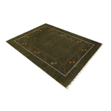 Side angle view of olive green Hand Woven Loom Lori wool rug highlighting natural wool texture, minimal floral pattern and handmade finish