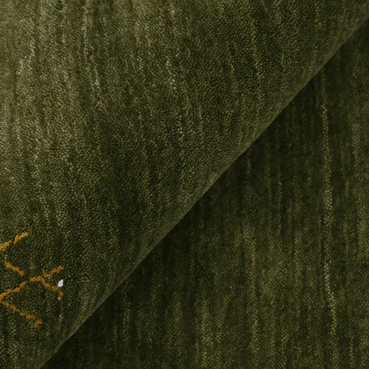 Close-up of olive green Hand Woven Loom Lori wool rug showing natural wool texture and detailed symbolic tribal motifs