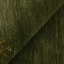 Close-up of olive green Hand Woven Loom Lori wool rug showing natural wool texture and detailed symbolic tribal motifs