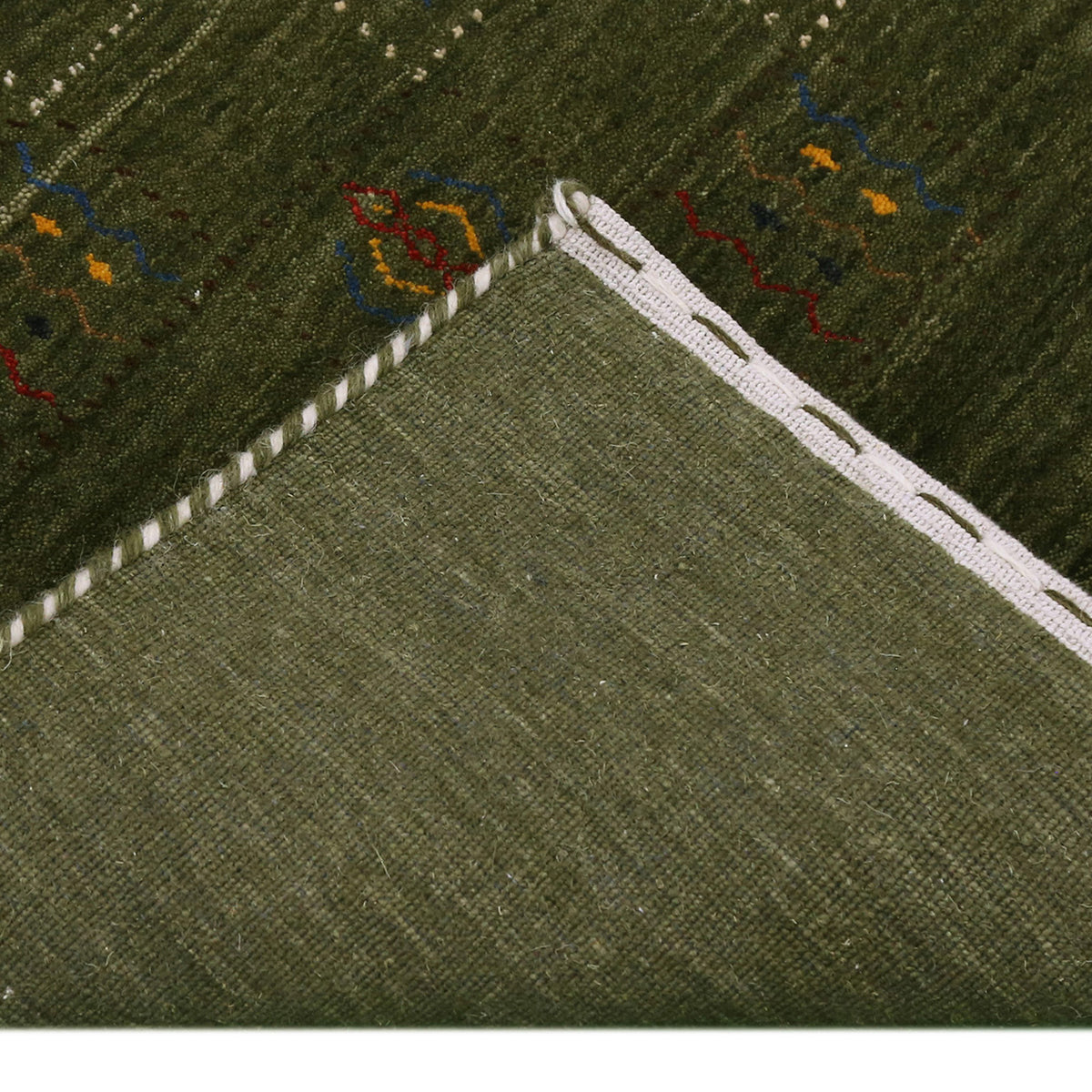 Corner and edge detail of olive green Hand Woven Loom Lori wool rug showing natural wool texture and handcrafted finishing