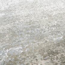 Close-up of the hand knotted wool and viscose texture with pearl grey ivory and taupe abstract detailing