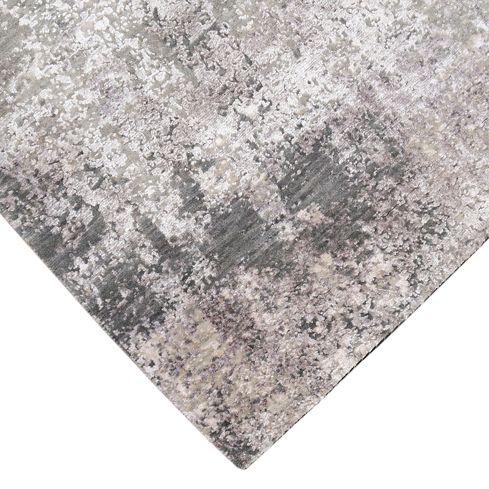 Hand-finished edge and softly distressed surface of the Pearl Sand hand knotted modern rug