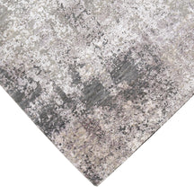 Hand-finished edge and softly distressed surface of the Pearl Sand hand knotted modern rug