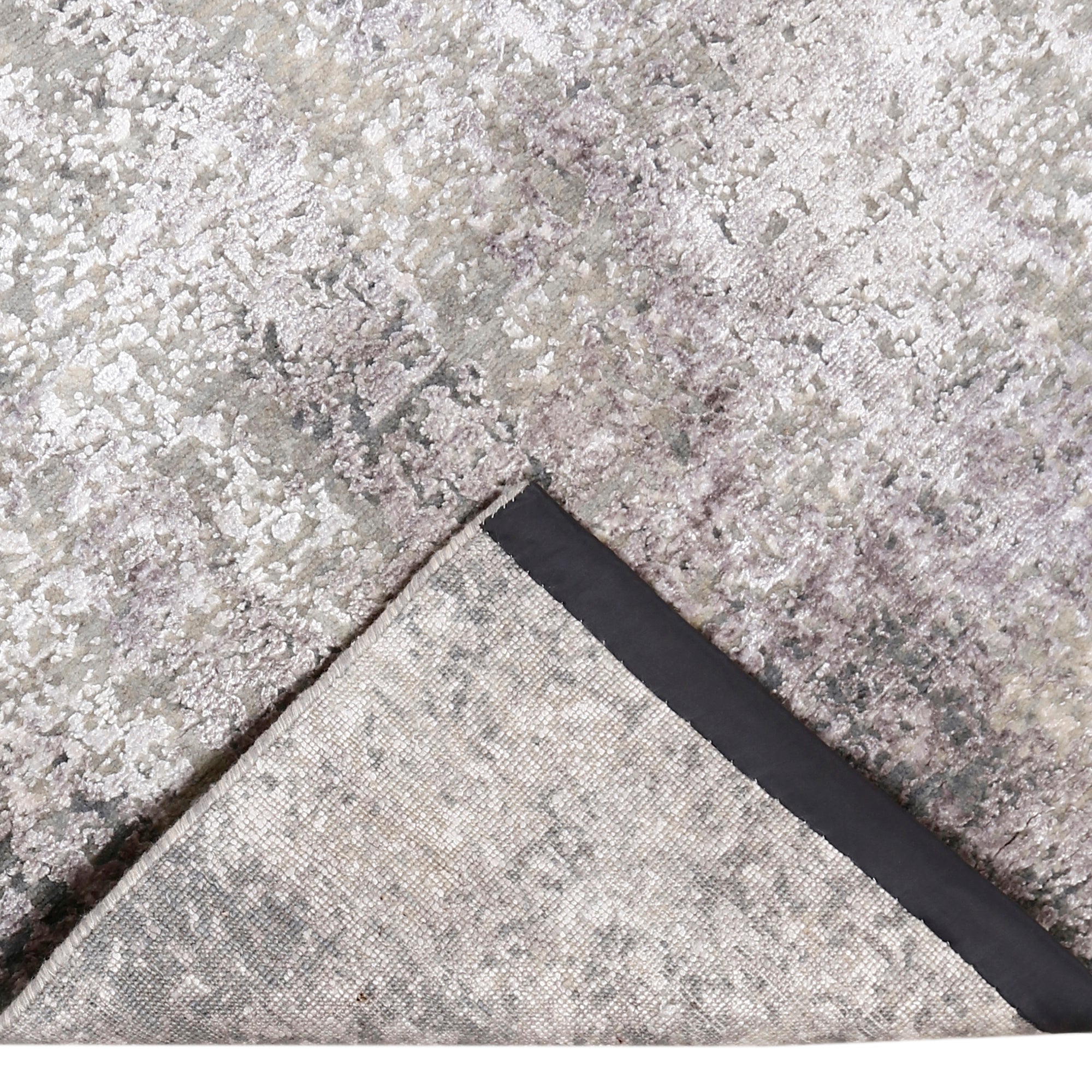 Hand-finished edge and softly distressed surface of the Pearl Sand hand knotted modern rug