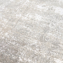 Close-up of the hand knotted wool and viscose texture with ivory beige taupe and silver grey abstract detailing