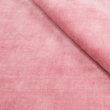 Close-up of pink Loom Lori wool rug highlighting its soft 12-15 mm pile, smooth wool texture and subtle tonal surface variations.