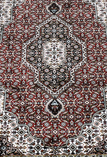 Close-up texture of Red Machine Woven Classic Art Silk Rug showing geometric motifs and smooth Art Silk surface