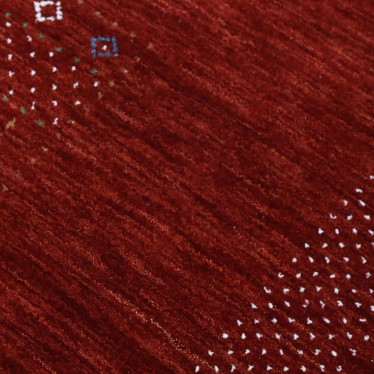 Close-up texture of red Hand Woven Loom Lori wool rug showing natural wool fibres and detailed tribal motifs