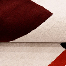 Close-up texture of the red hat lady hand tufted wool wall rug
