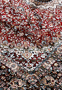 Close-up texture of Red Machine Woven Classic Art Silk Rug showing intricate floral detailing and smooth surface