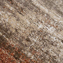 Close-up of the hand knotted wool and viscose texture with beige taupe ivory and rust abstract detailing