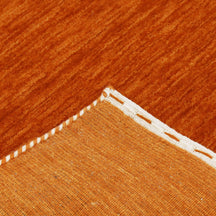 Corner and edge detail of rust orange Hand Woven Loom Lori wool rug showing handcrafted finish and geometric tribal motifs