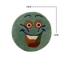 Full view of sage green round hand tufted wool kids rug featuring a cheerful smiley face with navy blue, ochre and cream details.