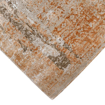 Hand-finished edge and faded ornamental detailing of the sandstone rust hand knotted rug
