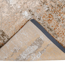 Hand-finished edge and faded ornamental detailing of the sandstone rust hand knotted rug