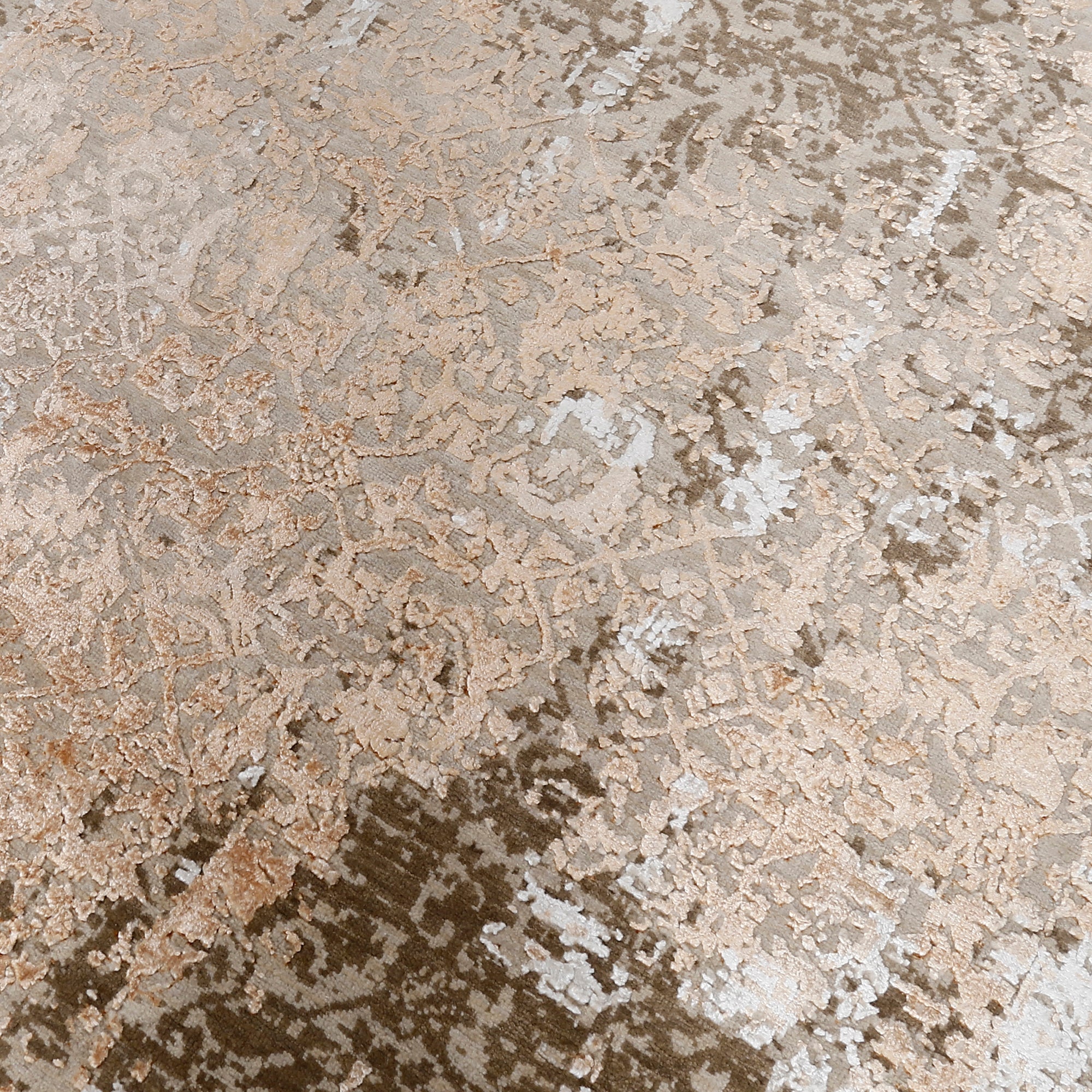 Close-up of the hand knotted wool and viscose texture with sandstone beige taupe and rust distressed detailing