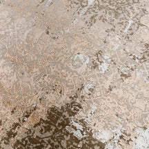 Close-up of the hand knotted wool and viscose texture with sandstone beige taupe and rust distressed detailing