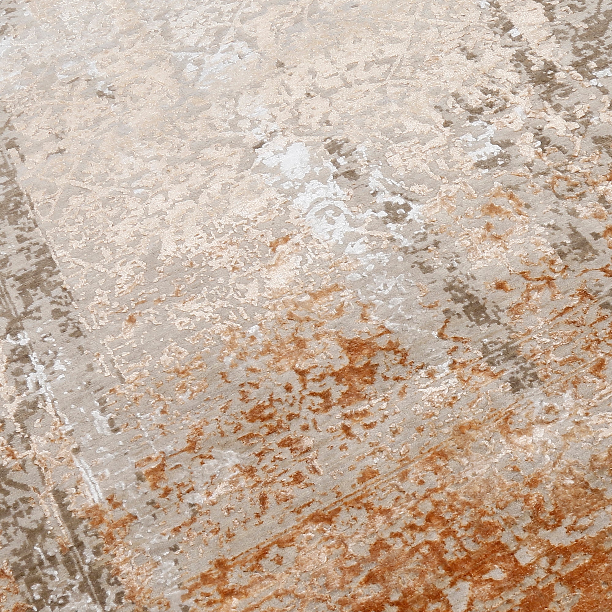 Close-up of the hand knotted wool and viscose texture with sandstone beige taupe and rust distressed detailing