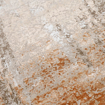 Close-up of the hand knotted wool and viscose texture with sandstone beige taupe and rust distressed detailing