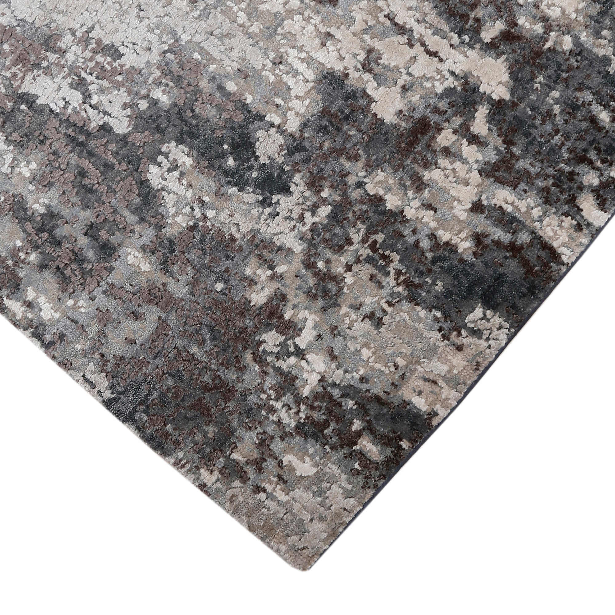 Hand-finished edge and layered distressed detailing of the silver ash abstract hand knotted rug