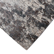 Hand-finished edge and layered distressed detailing of the silver ash abstract hand knotted rug