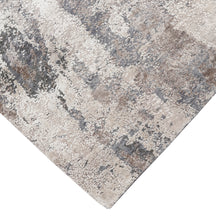 Hand-finished edge and textured abstract surface of the Silver Mist hand knotted modern rug