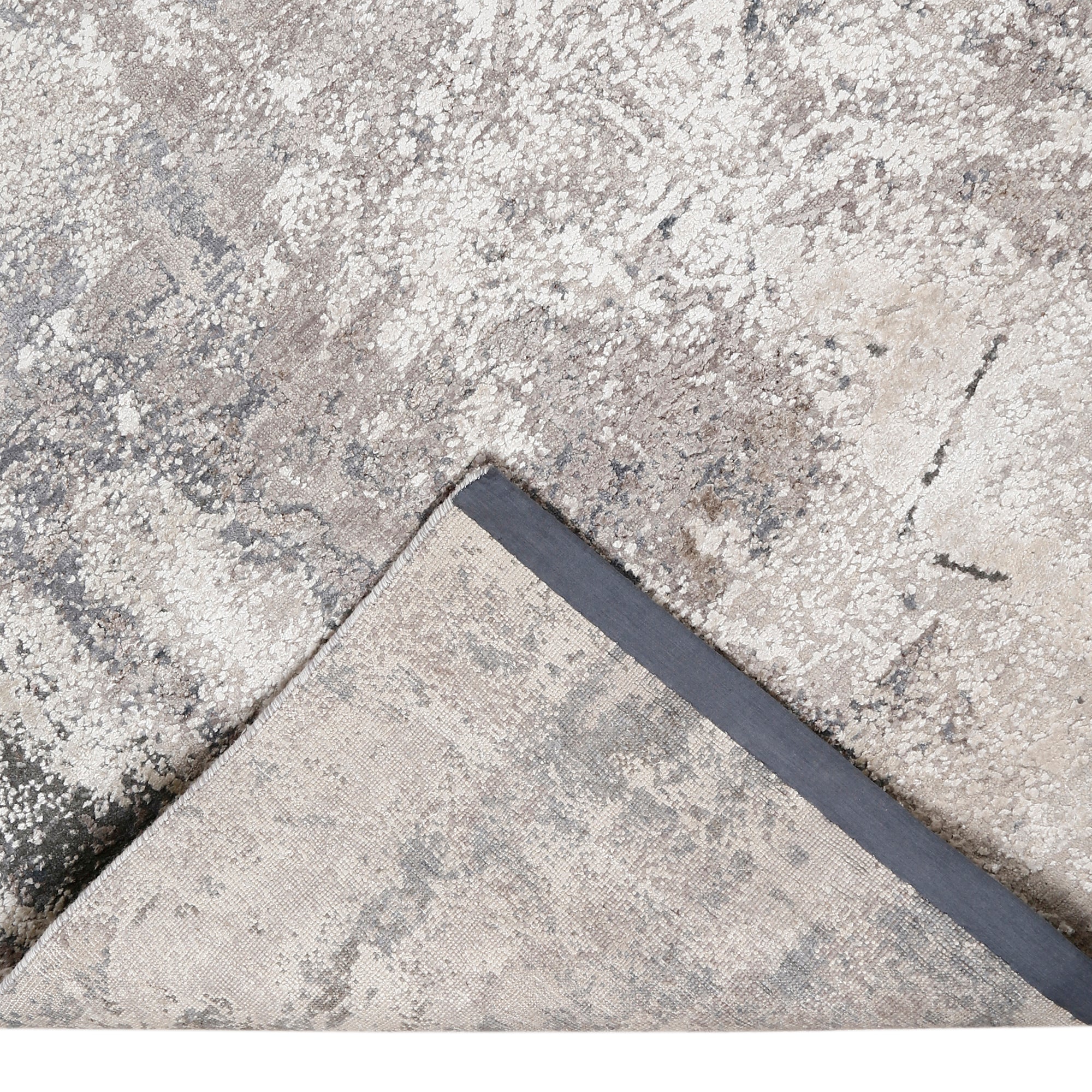 Hand-finished edge and textured abstract surface of the Silver Mist hand knotted modern rug