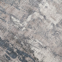 Close-up of the hand knotted wool and viscose texture with silver grey ivory beige and muted blue abstract detailing