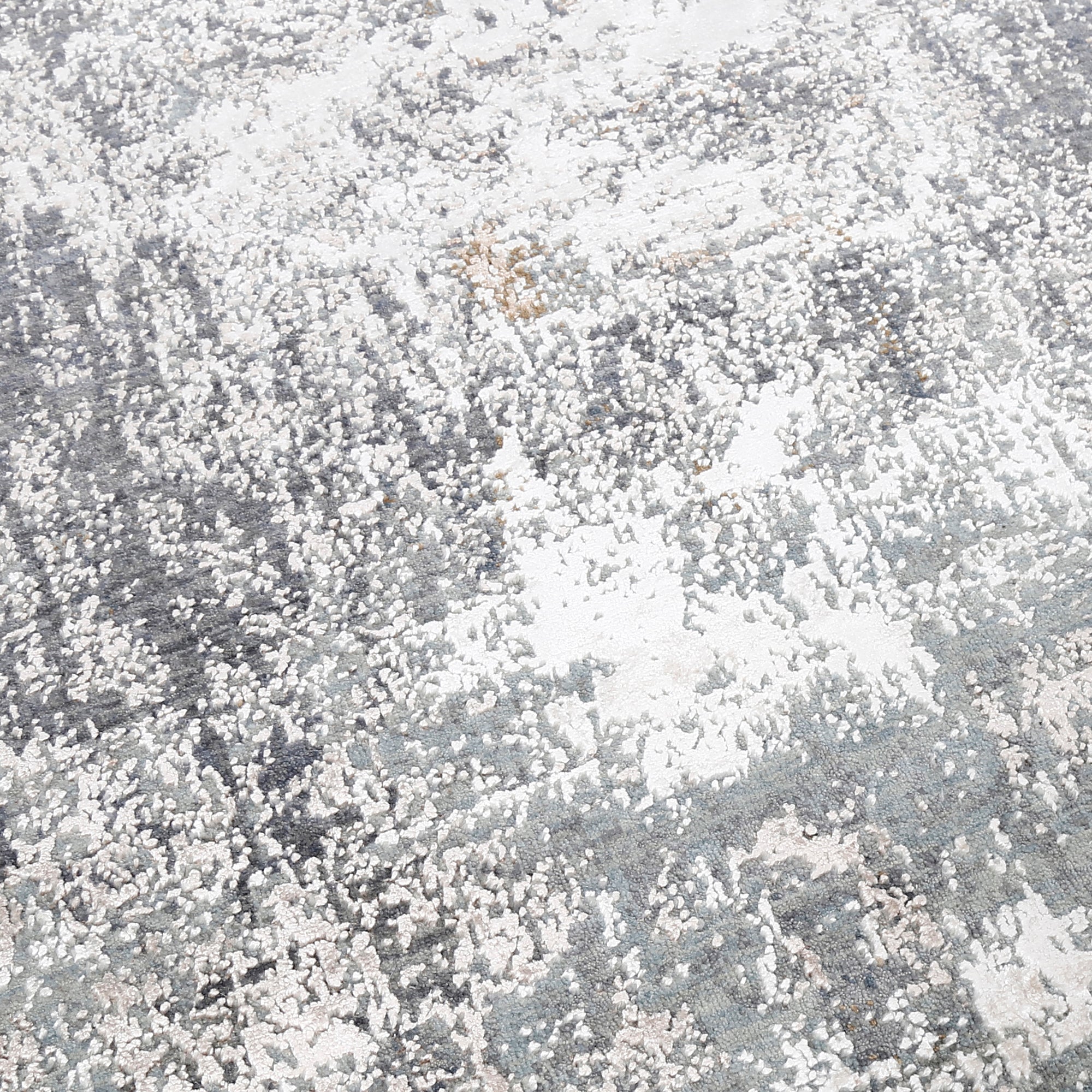 Close-up of the hand knotted wool and viscose texture with silver grey taupe and ivory abstract detailing