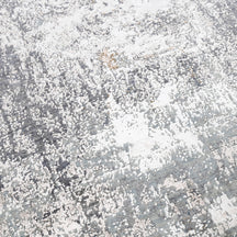 Close-up of the hand knotted wool and viscose texture with silver grey taupe and ivory abstract detailing