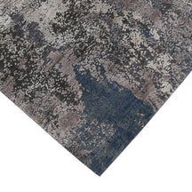 Hand-finished edge and textured abstract surface of the Silvermist Cascade hand knotted modern rug