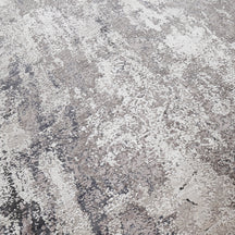 Close-up of the hand knotted wool and viscose texture with grey ivory and slate blue abstract detailing