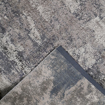 Hand-finished edge and textured abstract surface of the Silvermist Cascade hand knotted modern rug