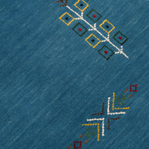 Close-up of sky blue Hand Woven Loom Lori wool rug showing central medallion, symbolic motifs and wool texture