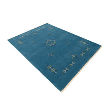 Side angle view of sky blue Hand Woven Loom Lori wool rug highlighting handwoven texture and artisan design