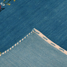Corner and edge detail of sky blue Hand Woven Loom Lori wool rug showing handcrafted finishing and geometric motifs