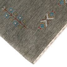 Corner and edge detail of olive grey Hand Woven Loom Lori wool rug showing handcrafted finishing and geometric tribal motifs