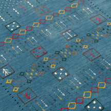 Close-up texture of teal blue Hand Woven Loom Lori wool rug showing natural wool fibres and geometric motif detailing