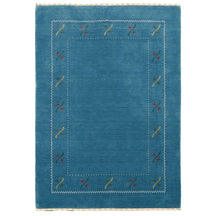 Full view of teal blue Hand Woven Loom Lori wool rug with multicolour floral motifs and delicate geometric border