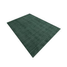 Angled perspective view of Teal Green Hand Woven Loom Lori wool rug showing its rectangular shape and textured surface.