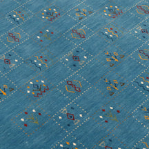 Close-up of teal blue Hand Woven Loom Lori wool rug showing dotted panels, geometric symbols and natural handcrafted wool texture