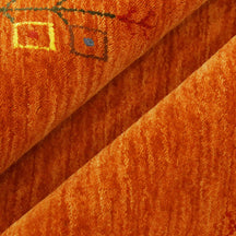 Close-up of rust orange Hand Woven Loom Lori wool rug showing central diamond motif, colourful folk details and natural wool texture