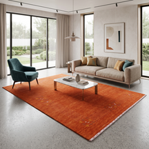 Terracotta orange Hand Woven Loom Lori wool rug with ivory dotted tribal border styled in a warm contemporary living room