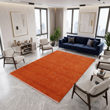 Terracotta orange Hand Woven Loom Lori wool rug with scattered tribal motifs styled in a warm contemporary living room