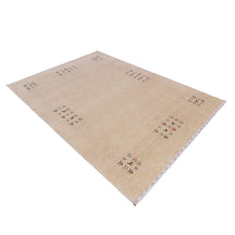 Side perspective of natural beige Hand Woven Loom Lori wool rug highlighting wool texture, dotted framing and tribal folk border design