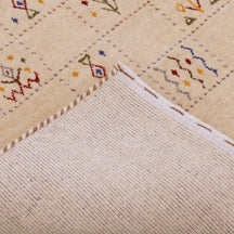 Corner and edge detail of warm beige Hand Woven Loom Lori wool rug showing natural wool texture and handcrafted finishing