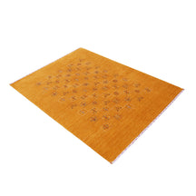 Side perspective of golden mustard Hand Woven Loom Lori wool rug highlighting handcrafted texture and minimal central folk motif arrangement
